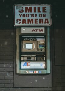 Bank ATM machine with a security camera notice sign